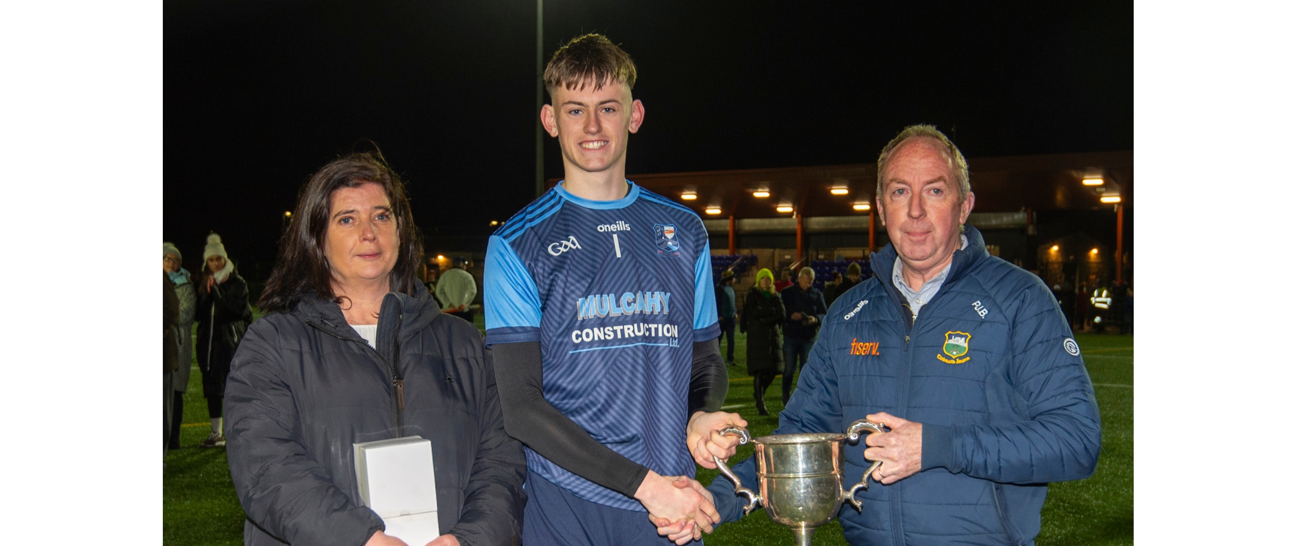 PJ Bowden, County Bord na nOg Chairman, presents the cup to Moyle Rovers captain James O’Brien. Also included is Michelle McKelvey, County Bord na nOg Secretary. Picture: Michael Boland