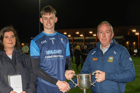 PJ Bowden, County Bord na nOg Chairman, presents the cup to Moyle Rovers captain James O’Brien. Also included is Michelle McKelvey, County Bord na nOg Secretary. Picture: Michael Boland
