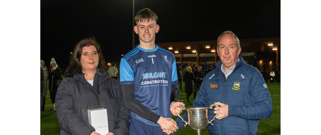 PJ Bowden, County Bord na nOg Chairman, presents the cup to Moyle Rovers captain James O’Brien. Also included is Michelle McKelvey, County Bord na nOg Secretary. Picture: Michael Boland