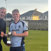 Moyle Rovers captain Conor O’Gorman receives the cup from Fintan O’Connor. Also included is Nicholas Moroney, Chairman of the South Tipperary GAA Board