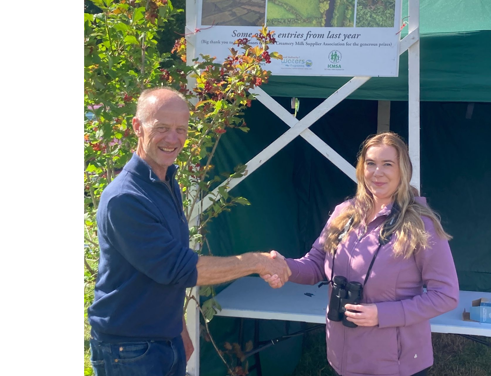Leane Coen being presented with her prize of a pair of binoculars by Alan Moore