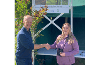 Leane Coen being presented with her prize of a pair of binoculars by Alan Moore