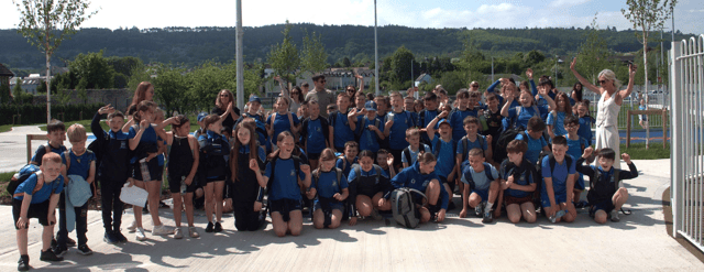 Gaescoil pupils and staff arriving at their new school on the North Quay in Carrick-on-Suir after walking from Carrick United FC in Carrickbeg where the school was based for 25 years