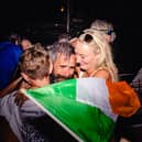 An emotional John O’Driscoll celebrates the achievement with his wife Aoife  and 10-year-old son Riain at the finish line