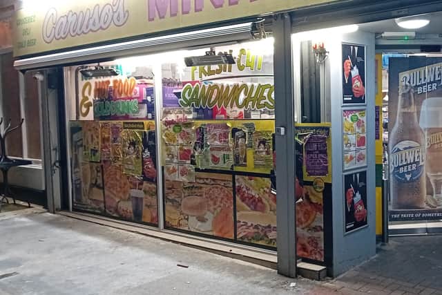 The transformation includes the installation of 'Mini Mart' signage on the existing shopfront of Gleeson's Spar on Catherine Street, US-style rubbish bins placed on footpaths, and vintage American cars parked on the street to replicate the period in which the film is set.