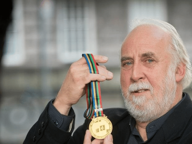 The late John Keating proudly displays the Gold Medal of Honour that he received at the Olympic Fine Arts 12 years ago