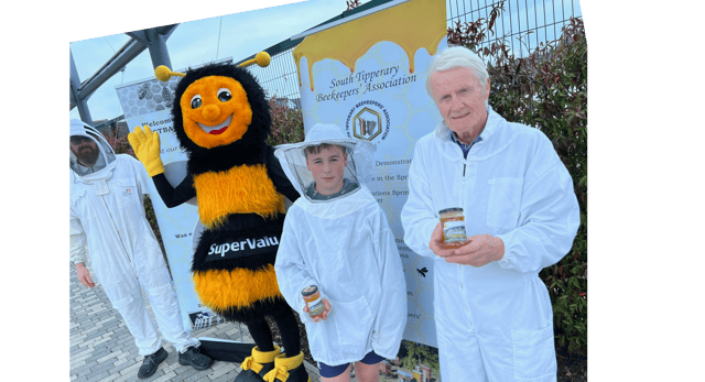 Mick McGrath, young beekeeper Ryan Lonergan and Paul Lonergan with the Honey Queen