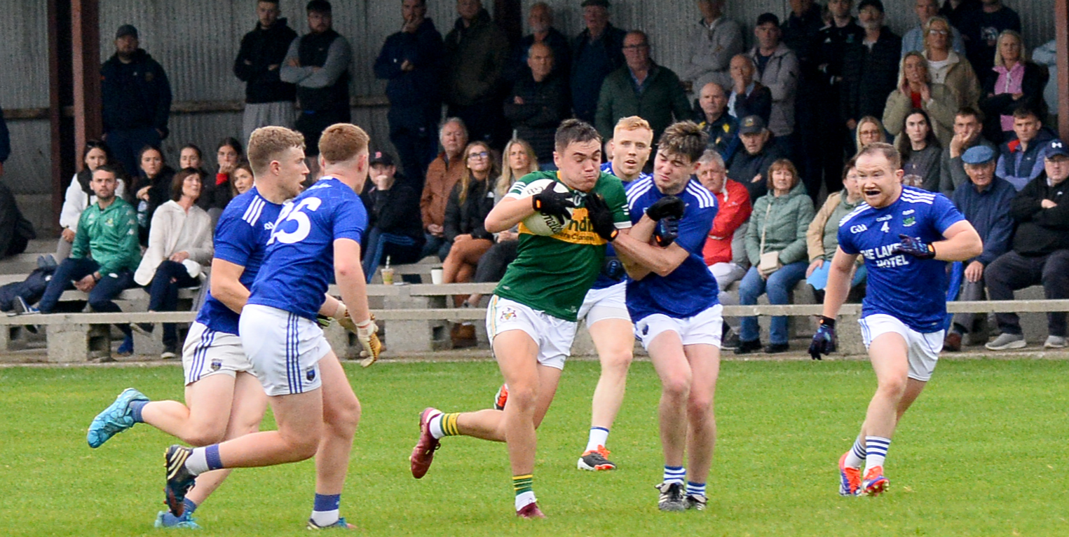 Peter McGarry, Clonmel Commercials, holds onto the ball despite being outnumbered by Ballina players. Picture: Michael Boland