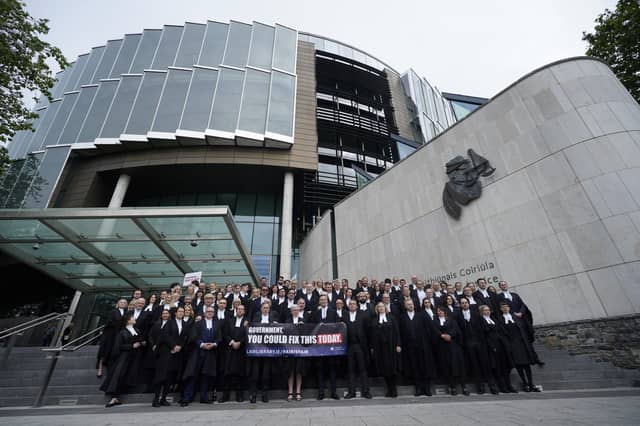 Criminal barristers take part in a demonstration outside the Criminal Courts of Justice in Dublin as they withdraw services amid ongoing fees dispute (Niall Carson/PA)