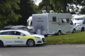 Photo shows the camper vans which have moved into the green field in Clara