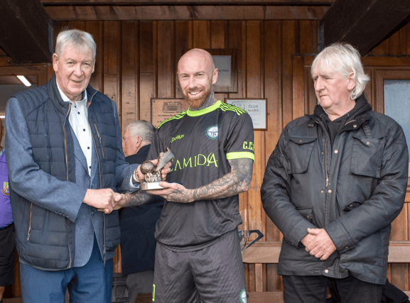 Man of the Match in last Saturday's Tipperary Cup, Philip Drohan (Clonmel Celtic) accepts his award from John Quirke, Jeweller, Cahir. On right is Liam Clohessy, Chairman TS&DL. Pic: Michael Boland