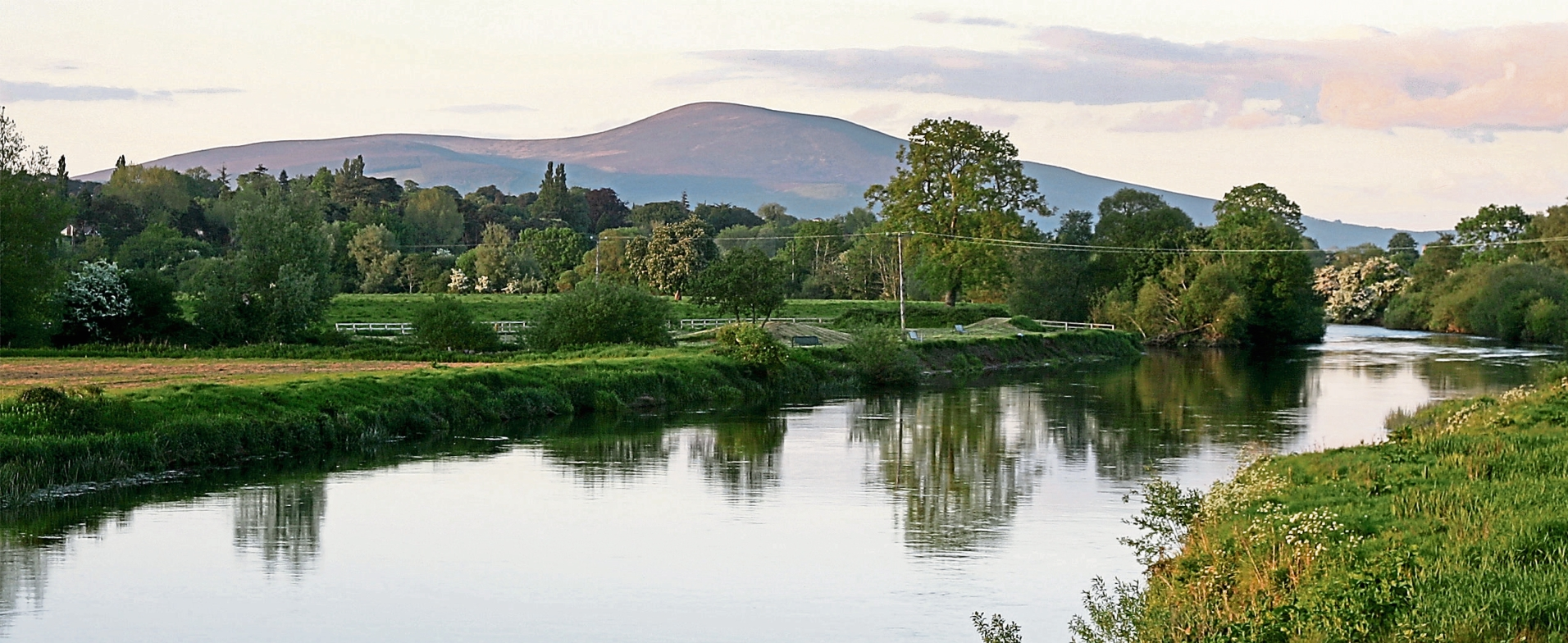 The Suir at Sandybanks upriver from Clonmel with Slievenamon in the background. Clonmel Rowing Club fully appreciates the value of the Suir as an amenity.