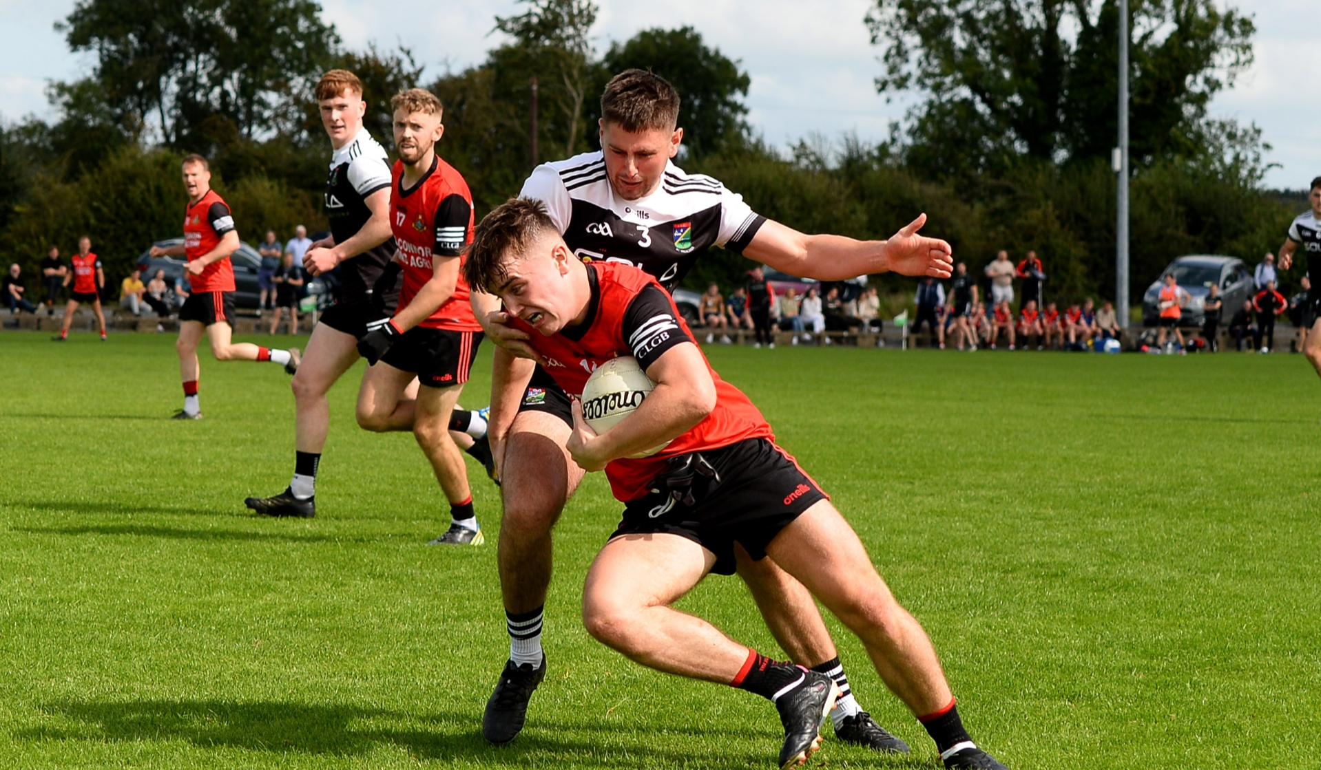 Ballyporeen's Darragh Brennan is tackled by Tom Murphy, JK Brackens. Picture: Michael Boland