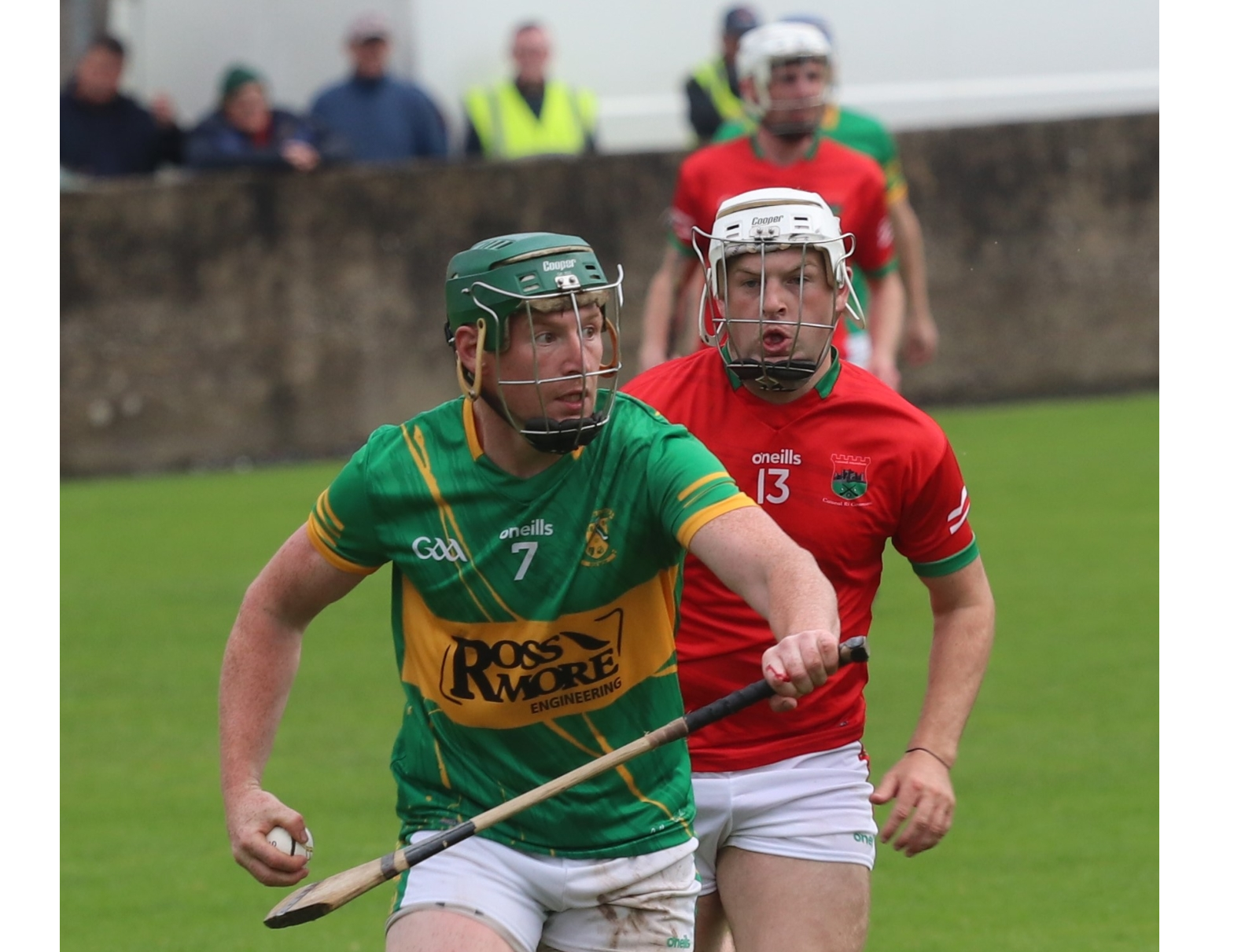 Clonoulty/Rossmore's Sean O'Connor comes out of defence with the ball, pursued by Devon Ryan of Cashel King Cormacs