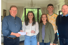 Noirin Forrestal hands over a cheque on behalf of the pupils at St Olivers National School Clonmel to Declan Ryan for the Dillon Quirke Foundation