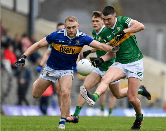 Tipperary defender Kevin Fahey puts pressure on Kerry's Sean O'Shea as he gets his shot away during today's Munster SFC semi-final at Killarney. Pic: Sportsfile