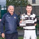 Carrick Swan captain Jamie Long receives the Doyle Cup from South GAA Board chairman Seamus Mullins, after their victory over St Patrick's in Saturday's South Junior B final. Picture: Michael Boland
