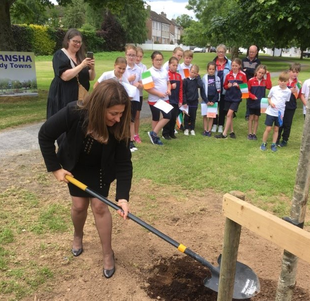 Ambassador of Palestine, planting a tree on the village green in Bansha, as part of her visit to the area