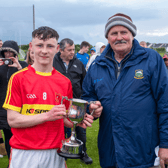 Killenaule captain Shane Ryan accepts the cup from County Bord na nÓg chairman, Tommy Landers, after Killenaule defeated Silvermines in the Under 15B county football final played at Leahy Park.
