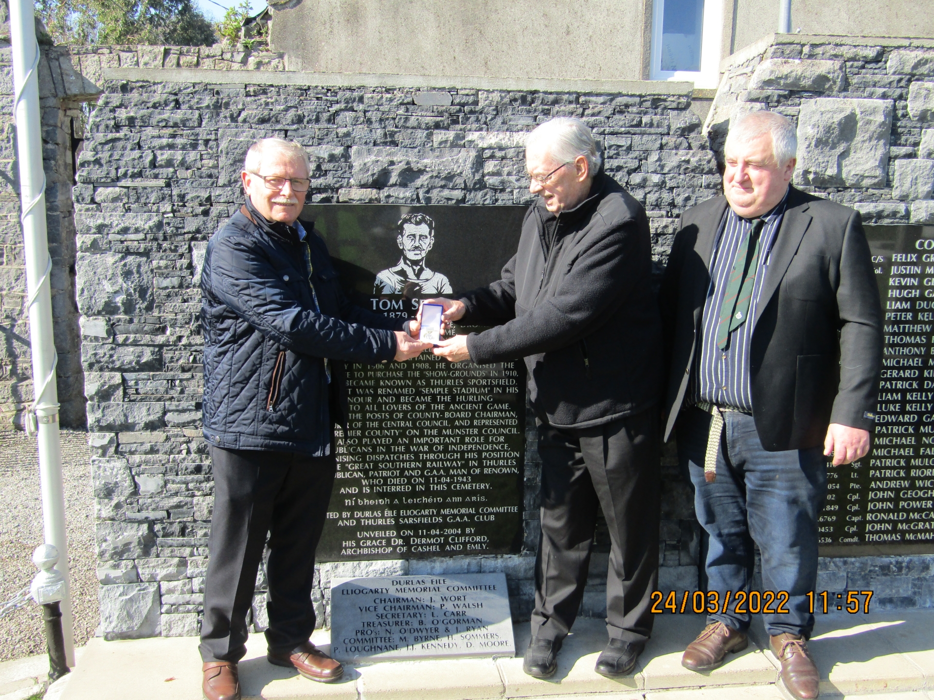 Johnny Wort presenting the Durlas Eile Eliogarty Memorial Committee Medal to  Martin Semple. Also present at St Mary’s International Garden of Remembrance  was William Ryan, Committee Member