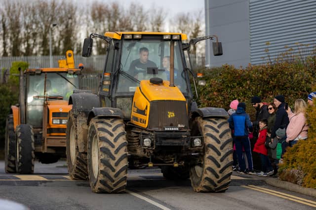 A crowd of spectators watch as tractors depart from Clonmel Park Hotel on Rathkeevin Macra na Feirme New Year's Eve tractor run. Picture John D Kelly