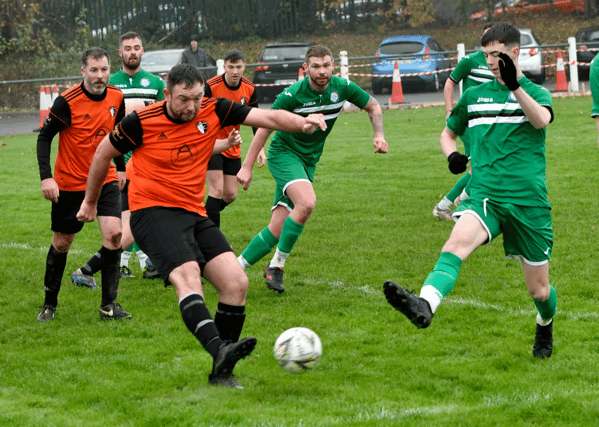 Niall Walsh (Kilsheelan United) gets his shot away as Clonmel Celtic B's Julian Kerton moves in to challenge in Sunday's Division 2 League game played at the By-Pass in Clonmel. Pic: Michael Boland.