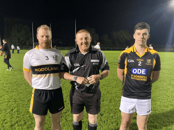 The referee calls the two captains together before the start of last Friday night's game at Cappawhite. From left to right: Michael Shanahan (Knockavilla Kickhams), Seanie Peters and Cian Quish (Emly)