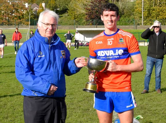 Skeheenarinky captain Fionán O'Sullivan accepts the South Tipperary Junior A Hurling Cup from South Board chairman, Nicholas Moroney. Pic: Michael Boland