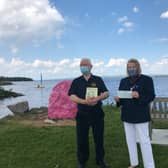 Joe Barry presenting Niamh McCutcheon with a cheque for the RNLI