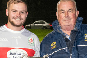 Mullinahone U-21 B football captain Brendan Kearney receives the cup from south board chairman Hugo Browne