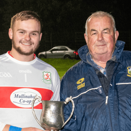 Mullinahone U-21 B football captain Brendan Kearney receives the cup from south board chairman Hugo Browne