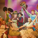 Irene Malone as Aunt Eller and James O'Donovan as Will Parker with the chorus performing in Carrick-on-Suir Musical Society's production of Oklahoma last Saturday night