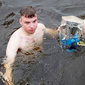 Liam McCarthy takes a dip in Lough Derg in the company of Newtown brothers Conor and Padraig Gill during the Christmas Day swim at Youghal Quay  Picture: Bridget Delaney