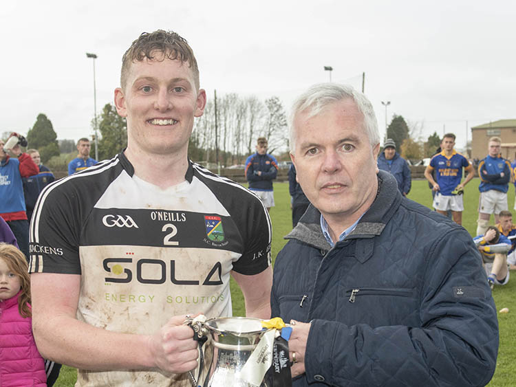 James Bergin (JK Bracken’s captain) pictured accepting the cup from Football Board chairman Barry O’Brien.