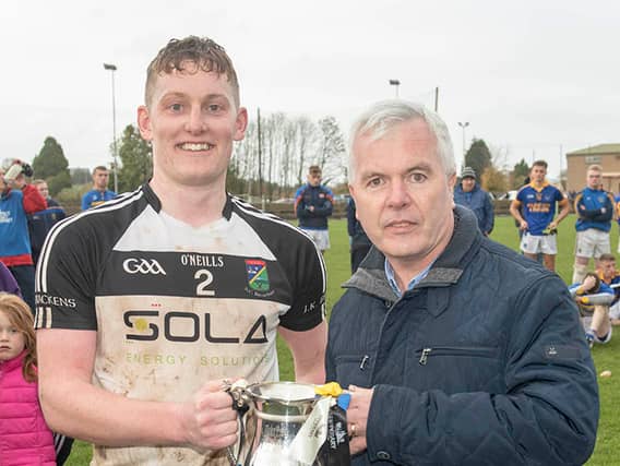 James Bergin (JK Bracken’s captain) pictured accepting the cup from Football Board chairman Barry O’Brien.