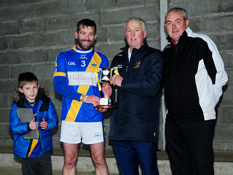 Boherlahan-Dualla captain Kevin O'Connell pictured accepting the Tim Maher Cup from County Board chairman John Devane. Also pictured are Cian O'Connell and PJ Maher. Photo: Eamonn McGee