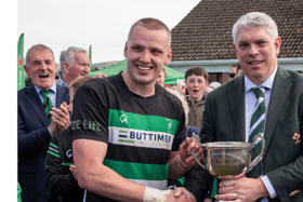 Clonmel captain Henry Buttimer receives the cup from David Ryan. Picture: Michael Boland