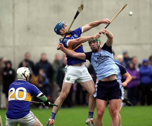 Reaching for the skies: Kiladangan's Joe Gallagher and Nenagh Éire Óg's Paddy Murphy pictured contesting a dropping ball watched by Jack Loughnane at Templederry on Saturday. Photo: Bridget Delaney