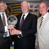 Denis Floyd receives  the Tipperary Person of the Year Award  from Louis Fitzgerald in the presence of Tipperary Association President Liam Myles.  Photograph: Bridget Delaney