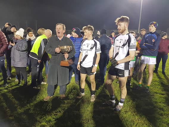 Kilruane MacDonagh’s joint-captains Kevin Oakley and Nathan Ryan pictured collecting the cup from County Football Board chairman Joe Hannigan at Dr Morris Park on Saturday night.