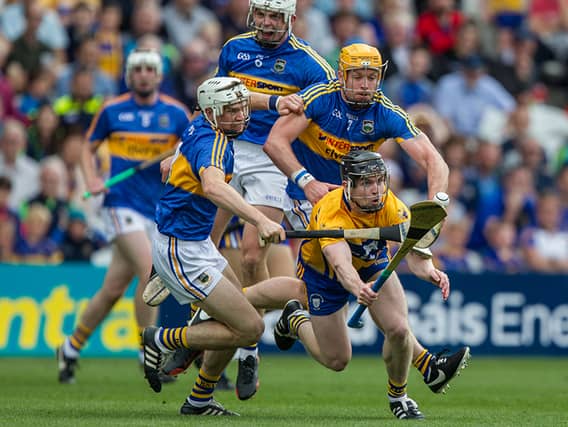 Pádraic Maher and Brendan Maher work to make life complicated for Clare's Tony Kelly.