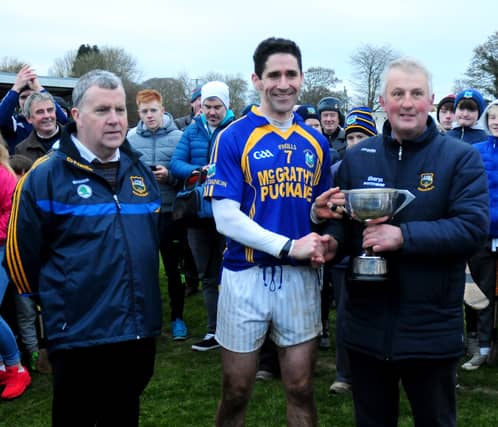 Kiladangan captain Gerry Slattery pictured accepting the junior A cup from County Board vice-chairman John Devane and CCC secretary Tom Maher. Photo: Eamon McGee