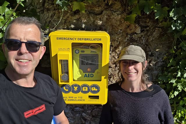 Johnny Comerford and Annie Hogg at the new defibrillator in Marlfield village