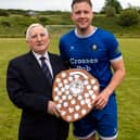 Benny Tynan, Chairman of the Tipperary Southern and District soccer League, presents the Division 3 Shield to Donohill captain Dinny Crosse