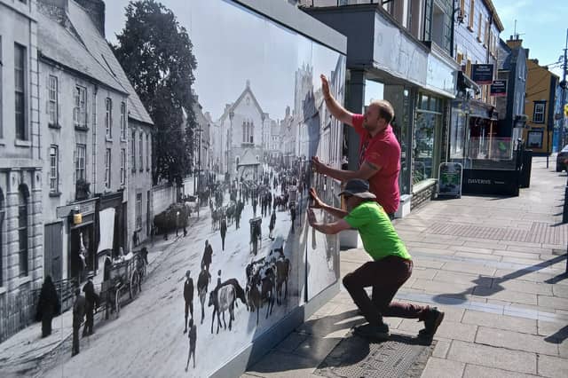 Cashel Tidy Town outside Kearney's Castle in Cashel with their new historic image of the town covering the hoarding.