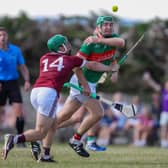 Loughmore/Castleiney's Noel McGrath plays a pass despite the challenge of Borris-Ileigh's James Devaney 