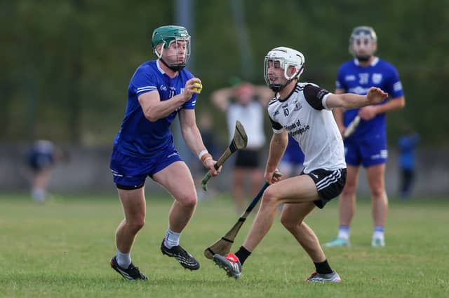 Darragh Stakelum, Thurles Sarsfields, braces himself for a tackle from Shane Cleary, Kilruane MacDonaghs