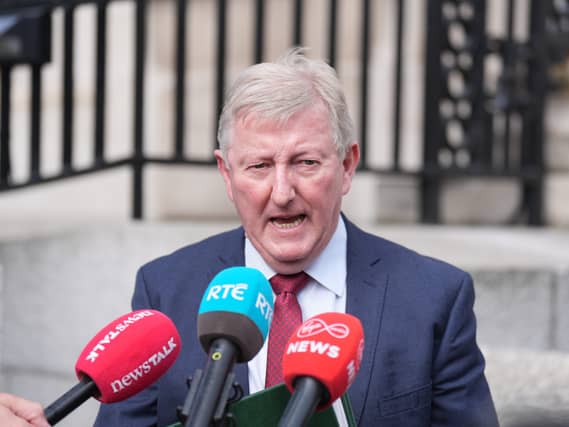 Head and shoulders photo of Sean Canney speaking into microphones outside a building
