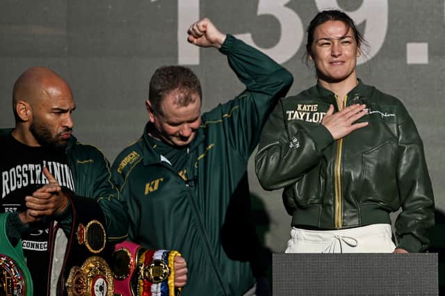 Katie Taylor with manager Brian Peters and trainer Ross Enamait, left, during the ceremonial weigh-ins, held at Trinity College