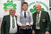James O'Brien from Tipperary South is presented with a bronze medal for Under 21 Conventional Junior by NPA chairman John Deery and NPA president Mick Mahon